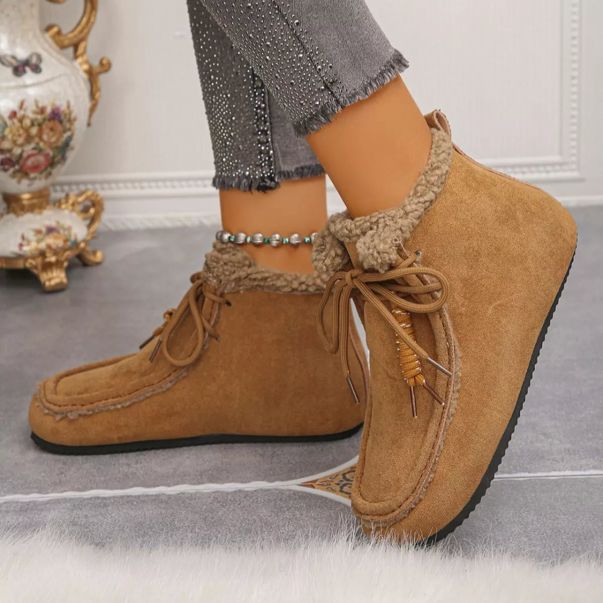 Women’s suede lace-up flat ankle boots with cozy fluffy trim in brown.