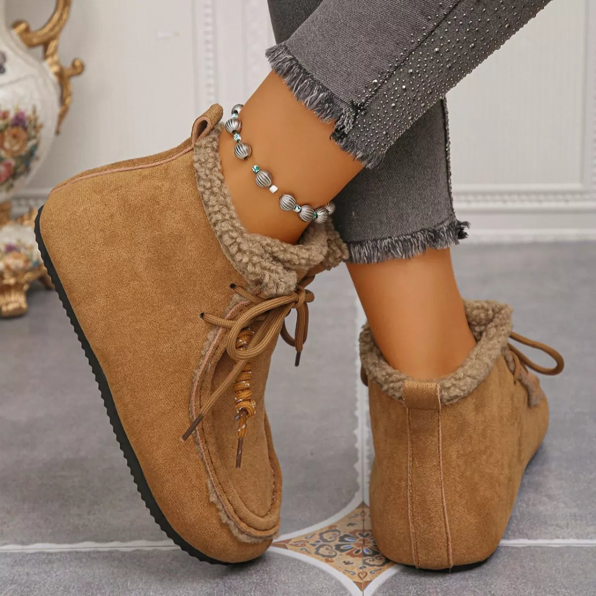 Women’s suede lace-up flat ankle boots with cozy fluffy trim in brown.