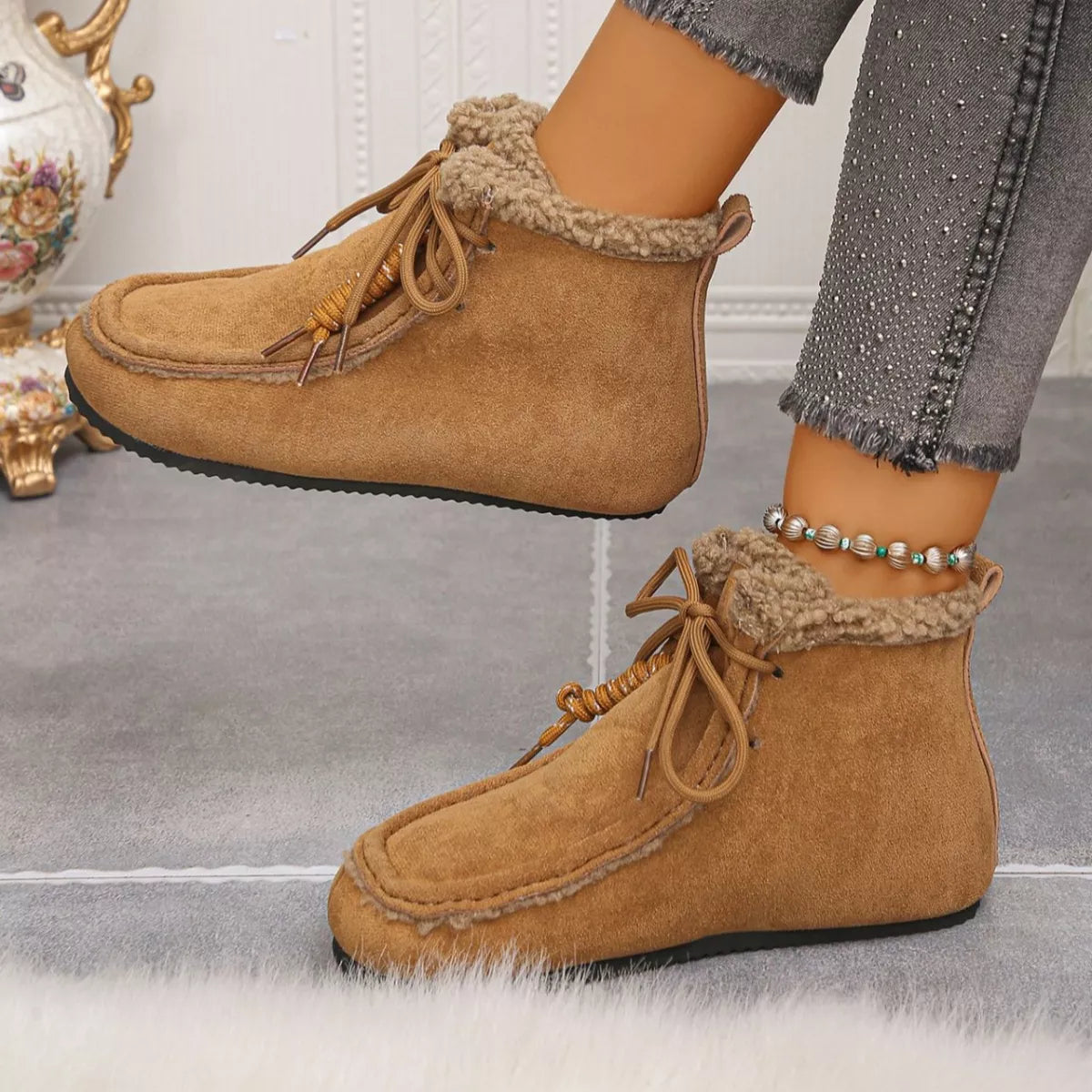 Women’s suede lace-up flat ankle boots with cozy fluffy trim in brown.