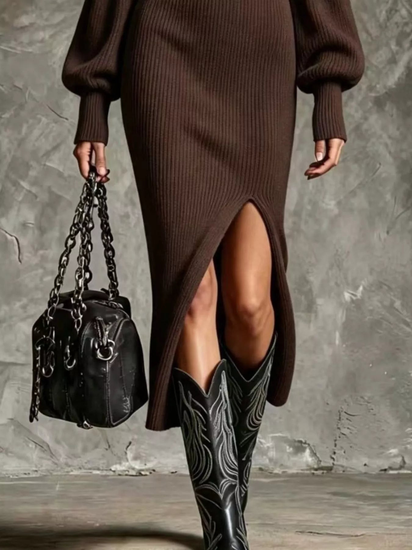 Woman wearing a brown ribbed knit quarter-zip sweater dress with long lantern sleeves, front slit and black embroidered western boots.
