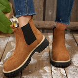 Brown suede round toe Chelsea ankle boots with black elastic side panels, mid-block heels and lug soles.