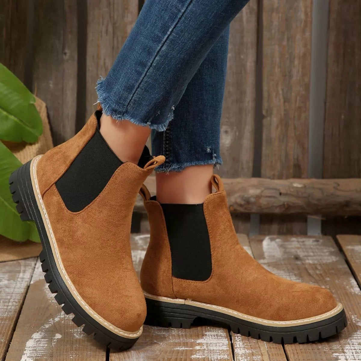 Brown suede round toe Chelsea ankle boots with black elastic side panels, mid-block heels and lug soles.