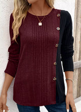 Women’s burgundy and black color block ribbed knit long sleeve top with decorative side buttons and slit detail, available in sizes Small–2XL.