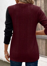 Women’s burgundy and black color block ribbed knit long sleeve top with decorative side buttons and slit detail, available in sizes Small–2XL.