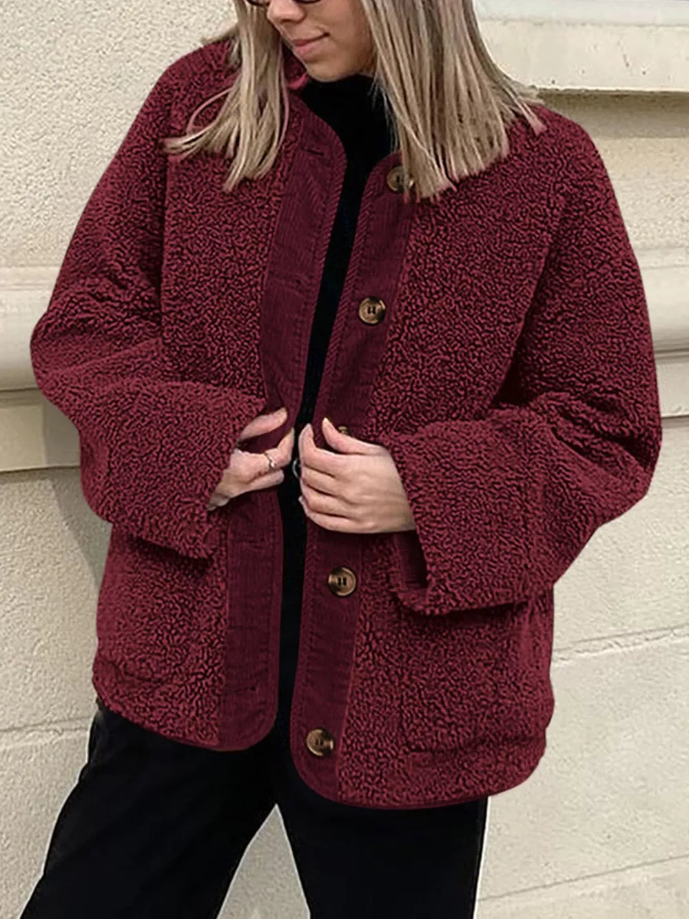 Women's burgundy contrast button up sherpa jacket with pockets and long sleeves.