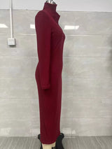 Woman wearing a burgundy ribbed knit V-neck long sleeve sweater dress styled with a black belt and tall brown Western boots.