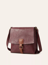 Burgundy vintage-style crossbody bag featuring a flap closure, decorative buckle detail, and adjustable shoulder strap.