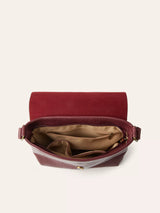 Open burgundy crossbody bag with multiple interior compartments and zippered pockets for organization.