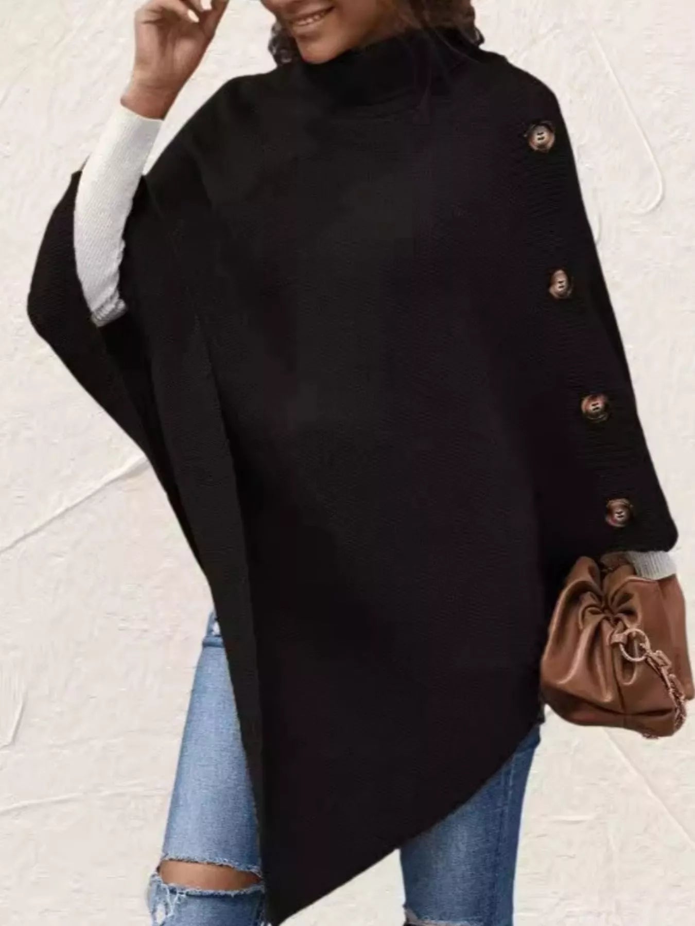 Women's black button-decor turtleneck poncho pullover with relaxed knit silhouette and draped hem.