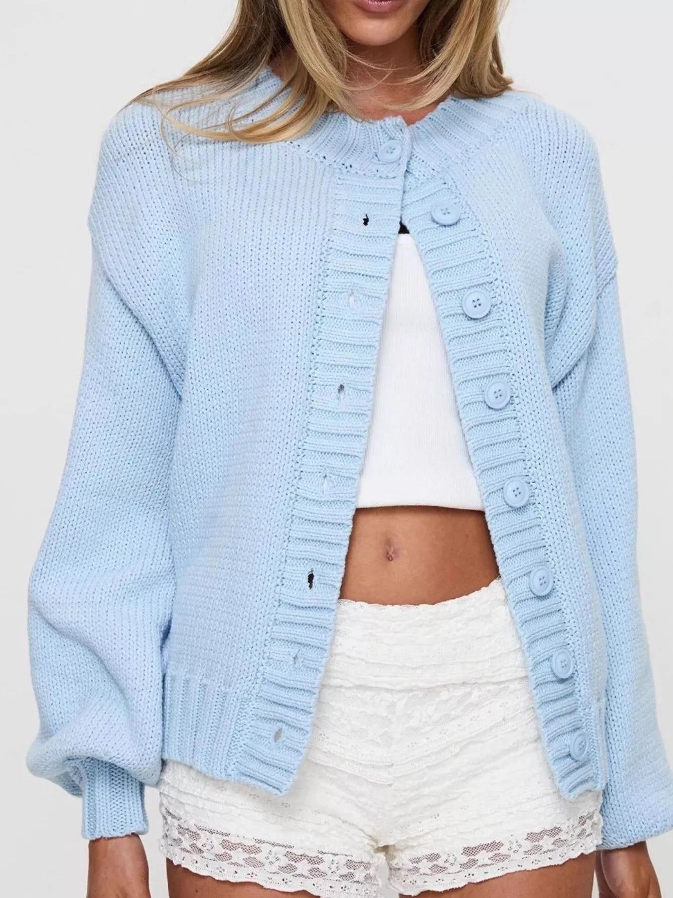 Women's blue button-down knit cardigan featuring a ribbed crew neckline, long sleeves, and relaxed fit. Cozy boutique sweater perfect for layering with jeans, dresses, or casual fall outfits.