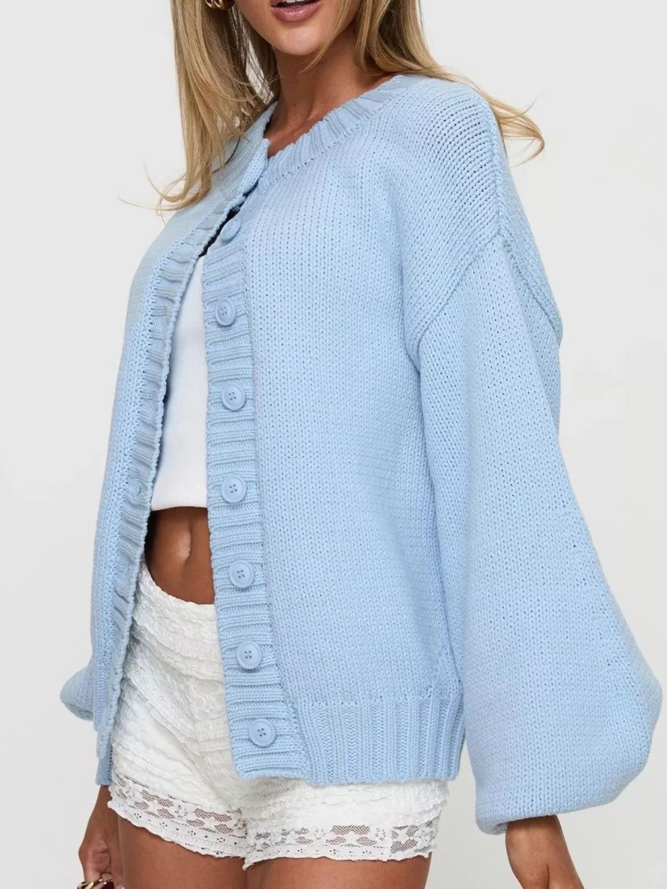 Women's blue button-down knit cardigan featuring a ribbed crew neckline, long sleeves, and relaxed fit. Cozy boutique sweater perfect for layering with jeans, dresses, or casual fall outfits.