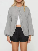 Women's gray button-down knit cardigan featuring a ribbed crew neckline, long sleeves, and relaxed fit. Cozy boutique sweater perfect for layering with jeans, dresses, or casual fall outfits.