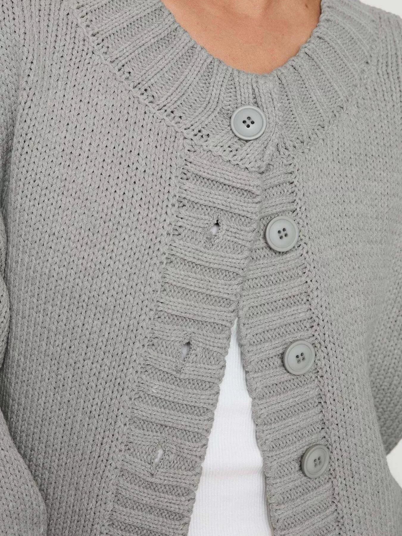 Women's gray button-down knit cardigan featuring a ribbed crew neckline, long sleeves, and relaxed fit. Cozy boutique sweater perfect for layering with jeans, dresses, or casual fall outfits.