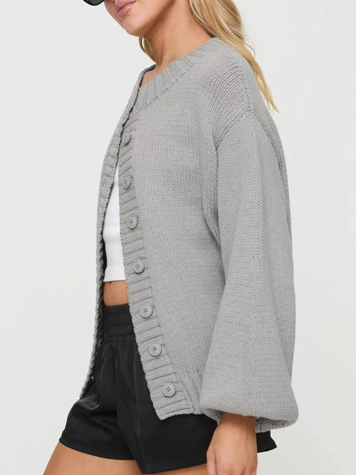 Women's gray button-down knit cardigan featuring a ribbed crew neckline, long sleeves, and relaxed fit. Cozy boutique sweater perfect for layering with jeans, dresses, or casual fall outfits.
