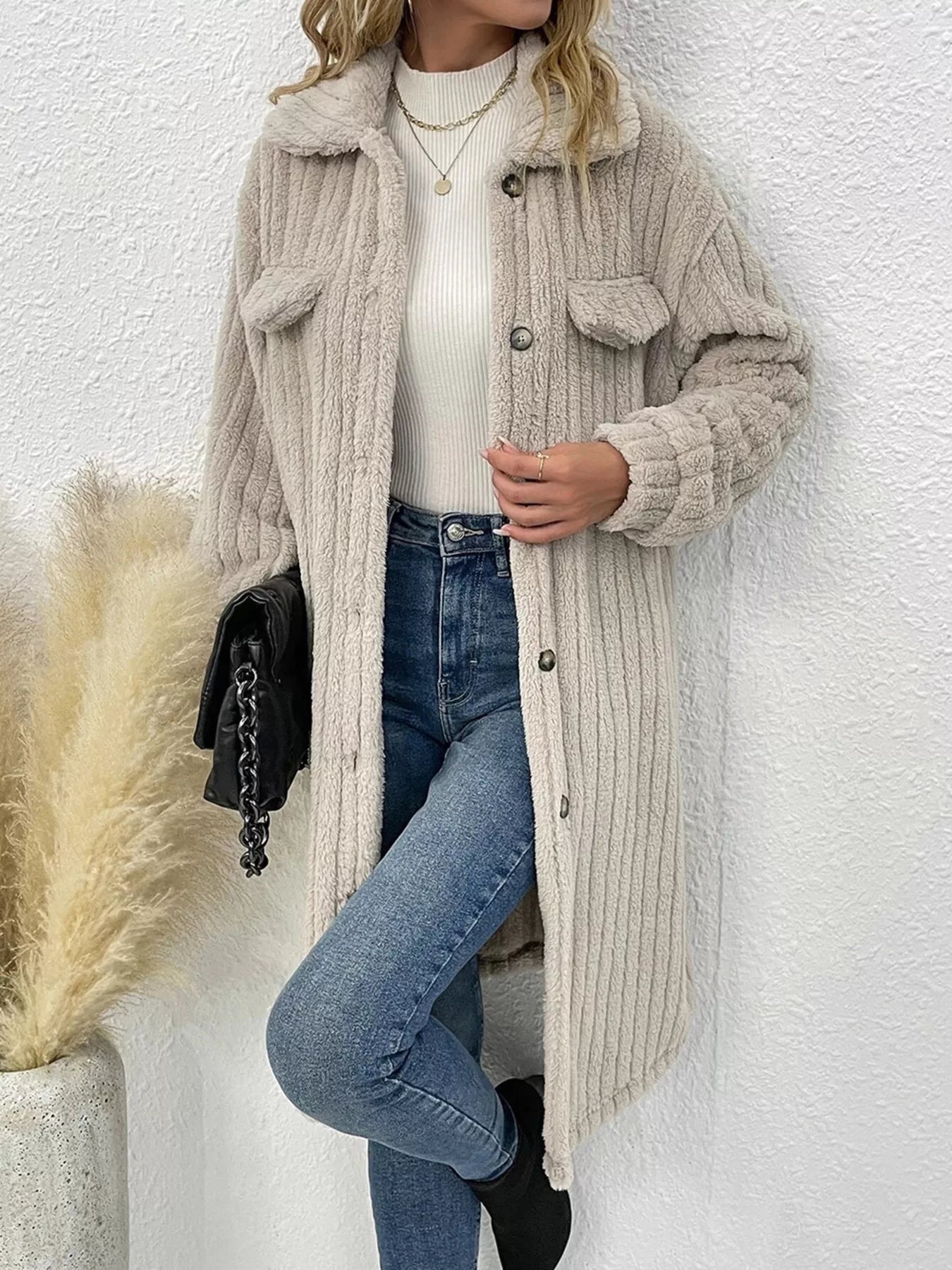 Women’s apricot textured button-down longline outerwear with pockets styled with a cream top and jeans