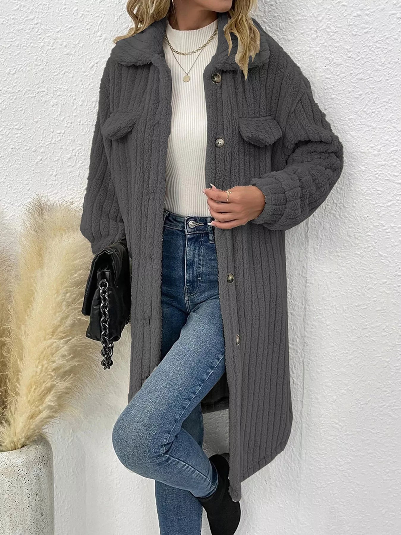 Women’s dark gray textured button-down longline outerwear with pockets styled with a cream top and jeans