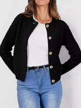Women's button-up cable-knit cardigan in black with long sleeves and textured knit, styled with denim for a classic fall outfit, available in sizes Small–2XL.