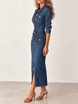 Woman wearing a dark blue button-front denim midi dress with gold-tone buttons, collared neckline, patch pockets, contrast stitching and front slit.