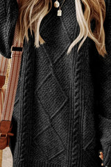 Woman wearing a black cable knit long sleeve sweater dress styled with knee-high brown boots and layered gold necklaces.