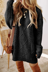 Woman wearing a black cable knit long sleeve sweater dress styled with knee-high brown boots and layered gold necklaces.