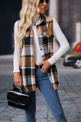 Woman wearing a camel plaid button-up vest coat layered over a white turtleneck with blue jeans and gold jewelry for a cozy fall outfit.