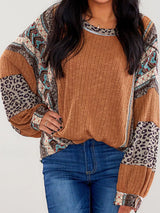 Women's caramel ribbed long sleeve top with leopard and Southwestern-inspired color block prints styled with blue jeans.