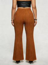 Model wearing caramel plus-size high-waisted flare pants styled with pointed-toe heels for an elegant and sophisticated look.