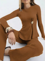 Woman wearing a caramel ribbed knit round neck top and matching pants two-piece sweater set with ruched detail.