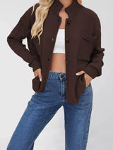 Women's casual knit button-down cardigan in brown featuring a stand collar, chest pocket, front pockets, and ribbed trim. Cozy boutique sweater perfect for layering with jeans and fall outfits.