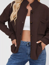 Women's casual knit button-down cardigan in brown featuring a stand collar, chest pocket, front pockets, and ribbed trim. Cozy boutique sweater perfect for layering with jeans and fall outfits.