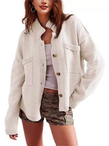 Women's casual knit button-down cardigan in ivory featuring a stand collar, chest pocket, front pockets, and ribbed trim. Cozy boutique sweater perfect for layering with jeans and fall outfits.