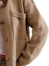 Women's casual knit button-down cardigan in khaki featuring a stand collar, chest pocket, front pockets, and ribbed trim. Cozy boutique sweater perfect for layering with jeans and fall outfits.