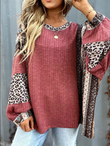 Women's cerise ribbed long sleeve top with leopard and Southwestern-inspired color block prints styled with blue jeans.