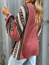 Women's cerise ribbed long sleeve top with leopard and Southwestern-inspired color block prints styled with blue jeans.
