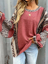 Women's cerise ribbed long sleeve top with leopard and Southwestern-inspired color block prints styled with blue jeans.