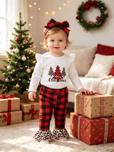 Baby girl wearing a Christmas tree graphic long sleeve top, red and black plaid ruffle pants and matching bow headband.