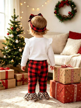 Baby girl wearing a Christmas tree graphic long sleeve top, red and black plaid ruffle pants and matching bow headband.