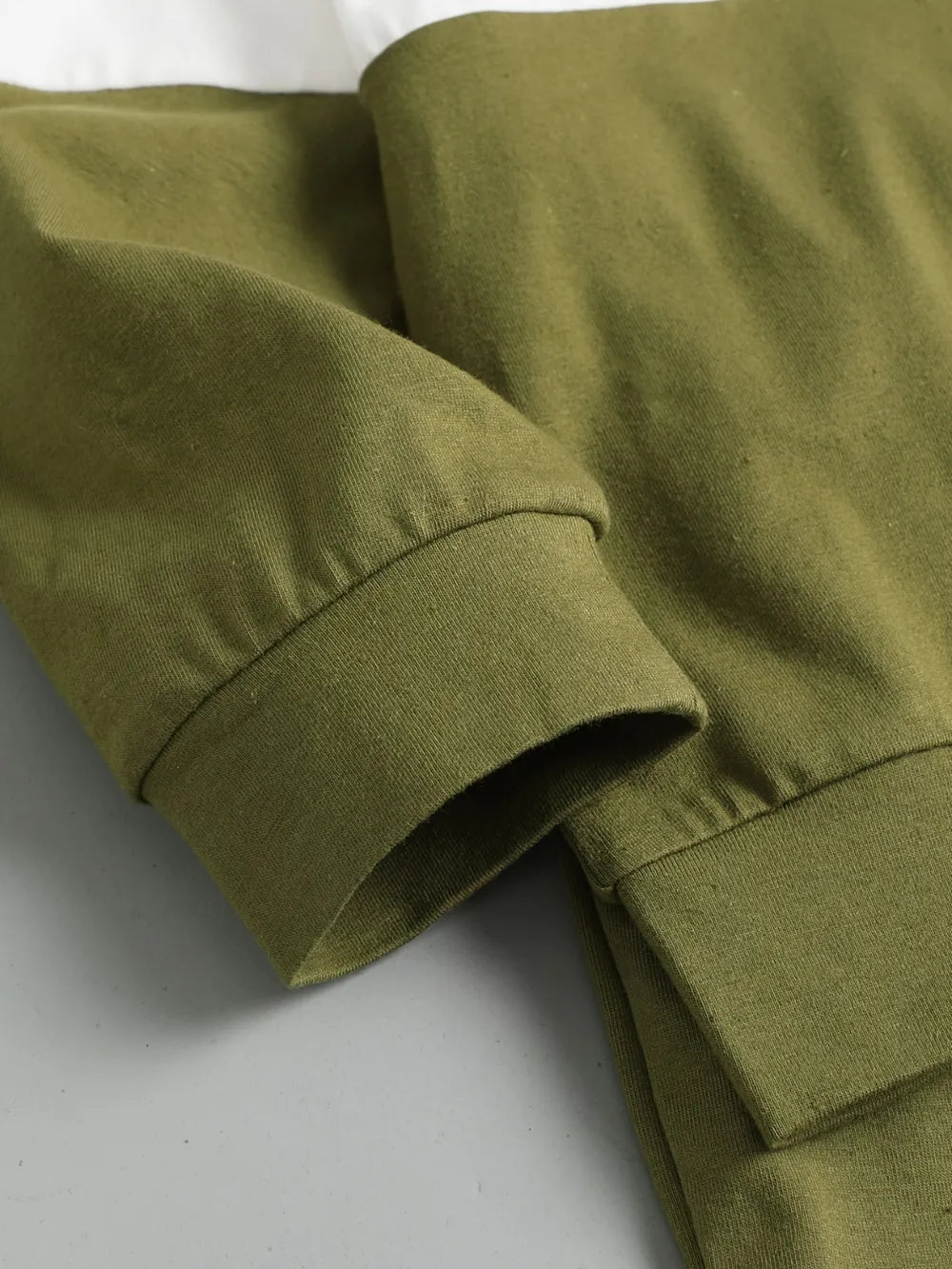 Children's olive green, cream, and beige color block long sleeve top with front chest pocket and matching olive-green pants, two-piece cotton blend outfit.