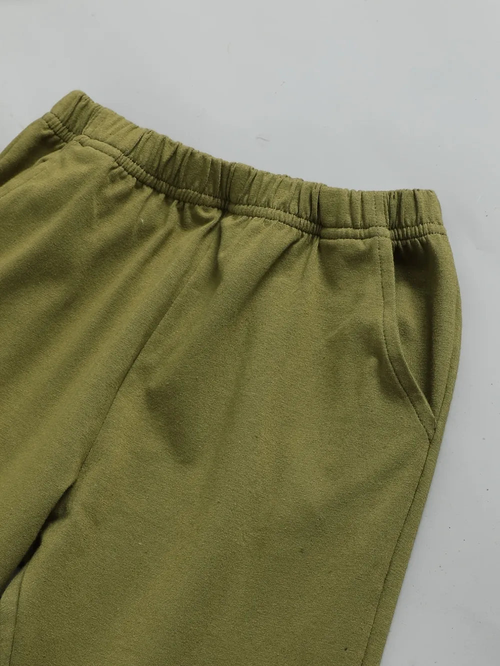 Children's olive green, cream, and beige color block long sleeve top with front chest pocket and matching olive-green pants, two-piece cotton blend outfit.
