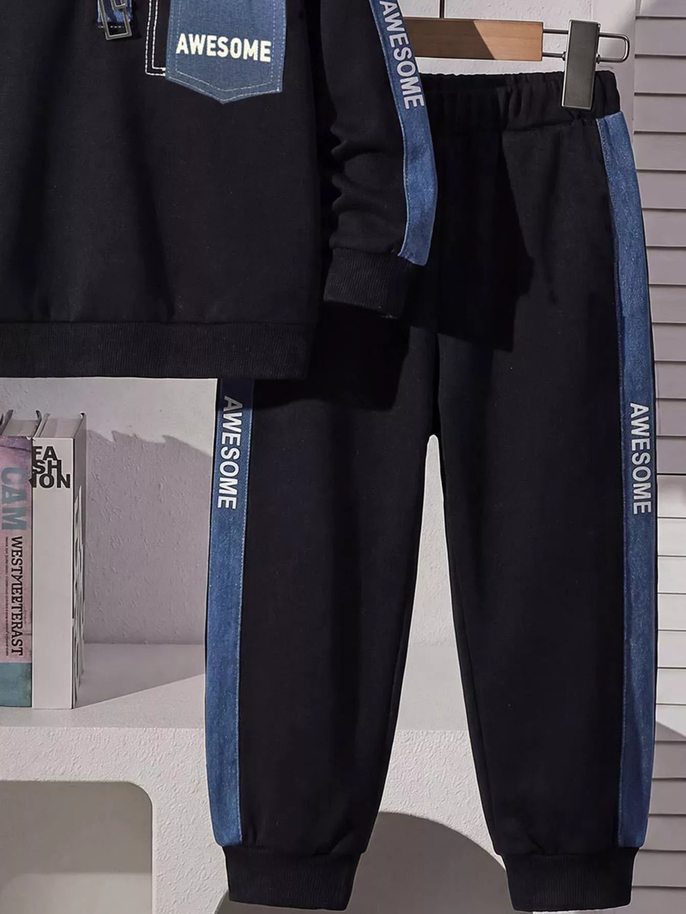 Children's navy two-piece outfit featuring a long sleeve polo shirt with denim-blue collar, AWESOME chest pocket and contrast sleeve stripes, paired with matching joggers.