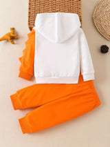 Children's white hooded sweatshirt with large orange dinosaur graphic and matching bright orange jogger-style pants.