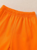 Children's white hooded sweatshirt with large orange dinosaur graphic and matching bright orange jogger-style pants.