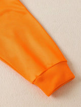 Children's white hooded sweatshirt with large orange dinosaur graphic and matching bright orange jogger-style pants.