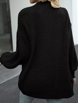 Women's oversized black chunky knit open front cardigan with long balloon sleeves, soft textured sweater perfect for fall layering with jeans.