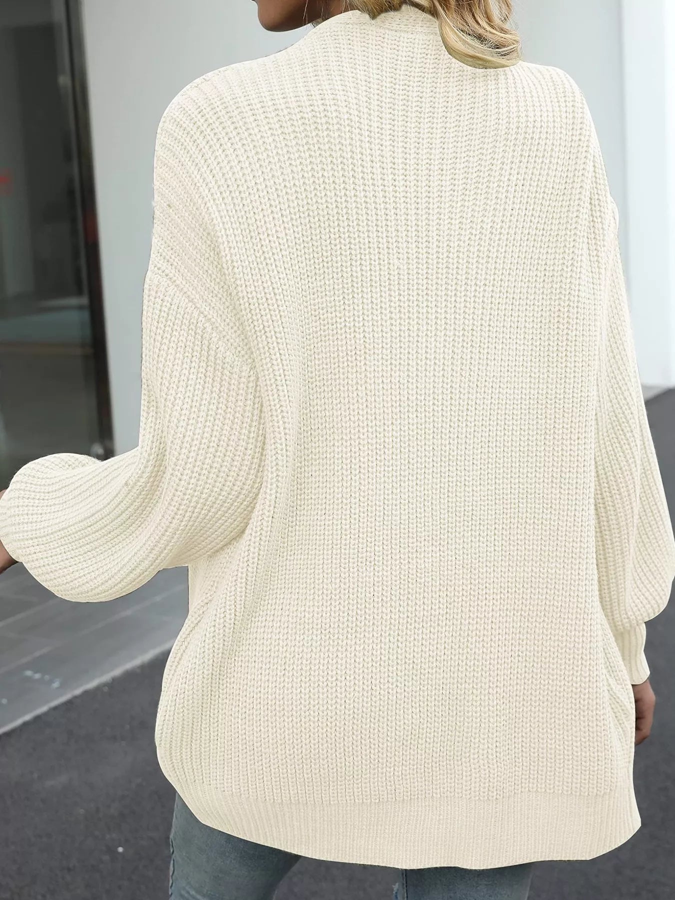Women's oversized beige chunky knit open front cardigan with long balloon sleeves, soft textured sweater perfect for fall layering with jeans.
