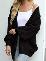Women's oversized black chunky knit open front cardigan with long balloon sleeves, soft textured sweater perfect for fall layering with jeans.