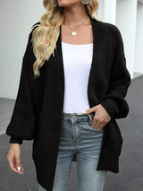 Women's oversized black chunky knit open front cardigan with long balloon sleeves, soft textured sweater perfect for fall layering with jeans.