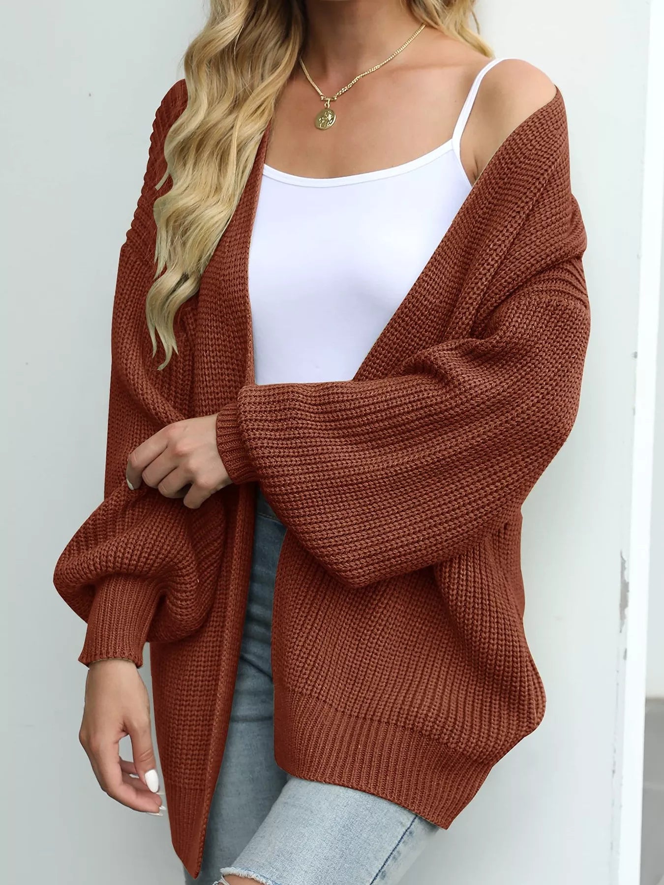 Women's oversized brown chunky knit open front cardigan with long balloon sleeves, soft textured sweater perfect for fall layering with jeans.