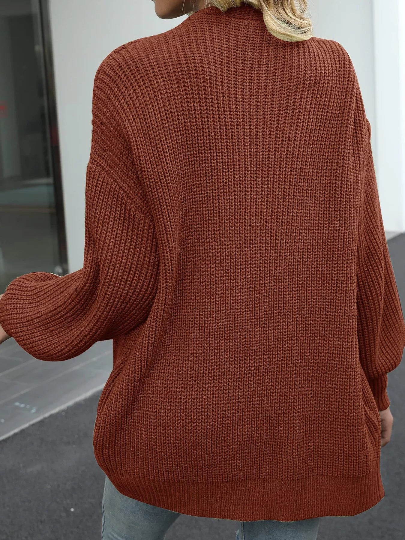Women's oversized brown chunky knit open front cardigan with long balloon sleeves, soft textured sweater perfect for fall layering with jeans.