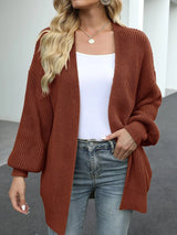 Women's oversized brown chunky knit open front cardigan with long balloon sleeves, soft textured sweater perfect for fall layering with jeans.